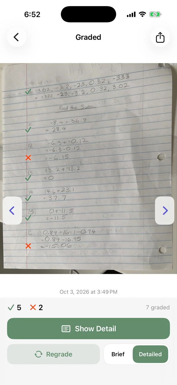 Matdo Grade showing checks and corrections on handwritten homework